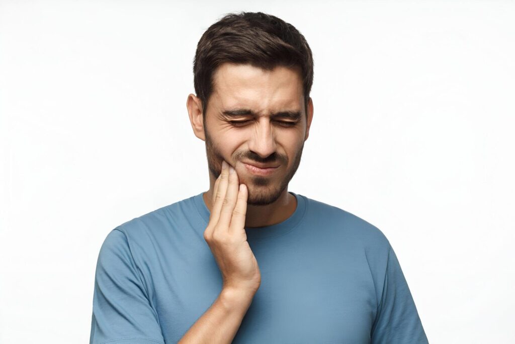 Tooth ache concept indoor shot young male feeling pain holding his cheek with hand suffering from bad toothache 1016700 3036